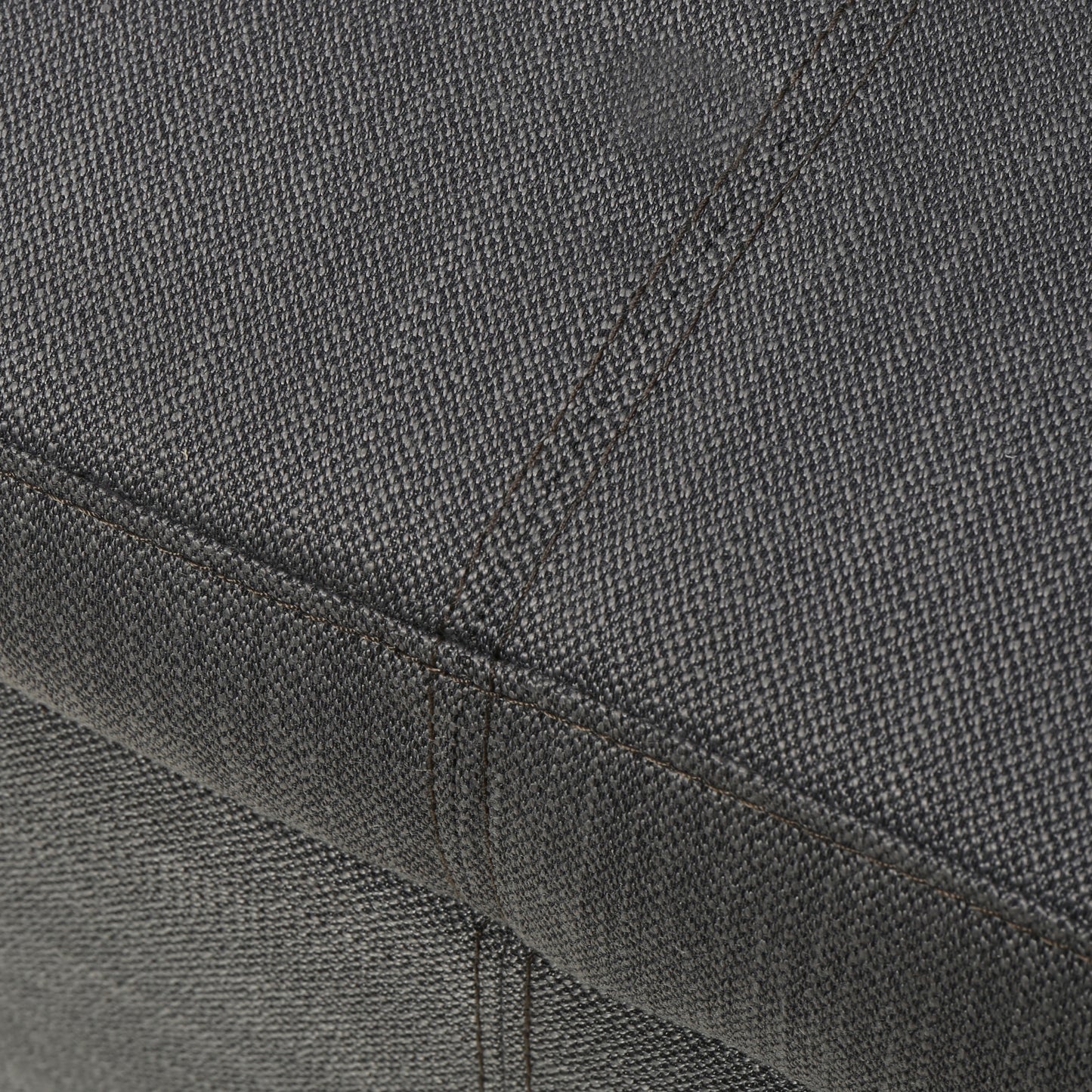 Dark grey textured fabric detail on a sofa cushion