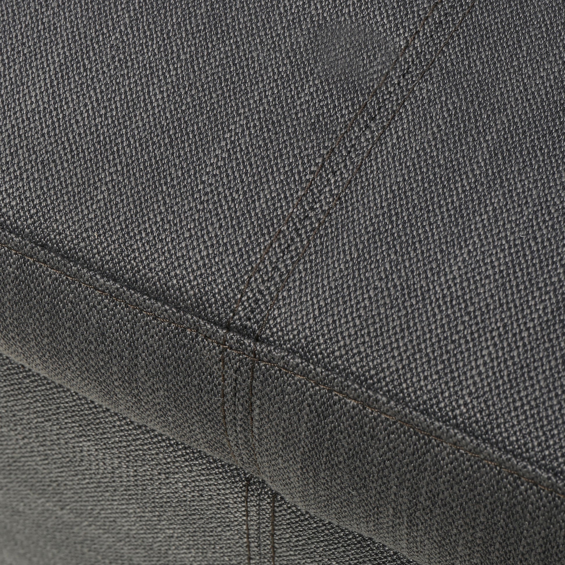 Dark grey textured fabric detail on a sofa cushion