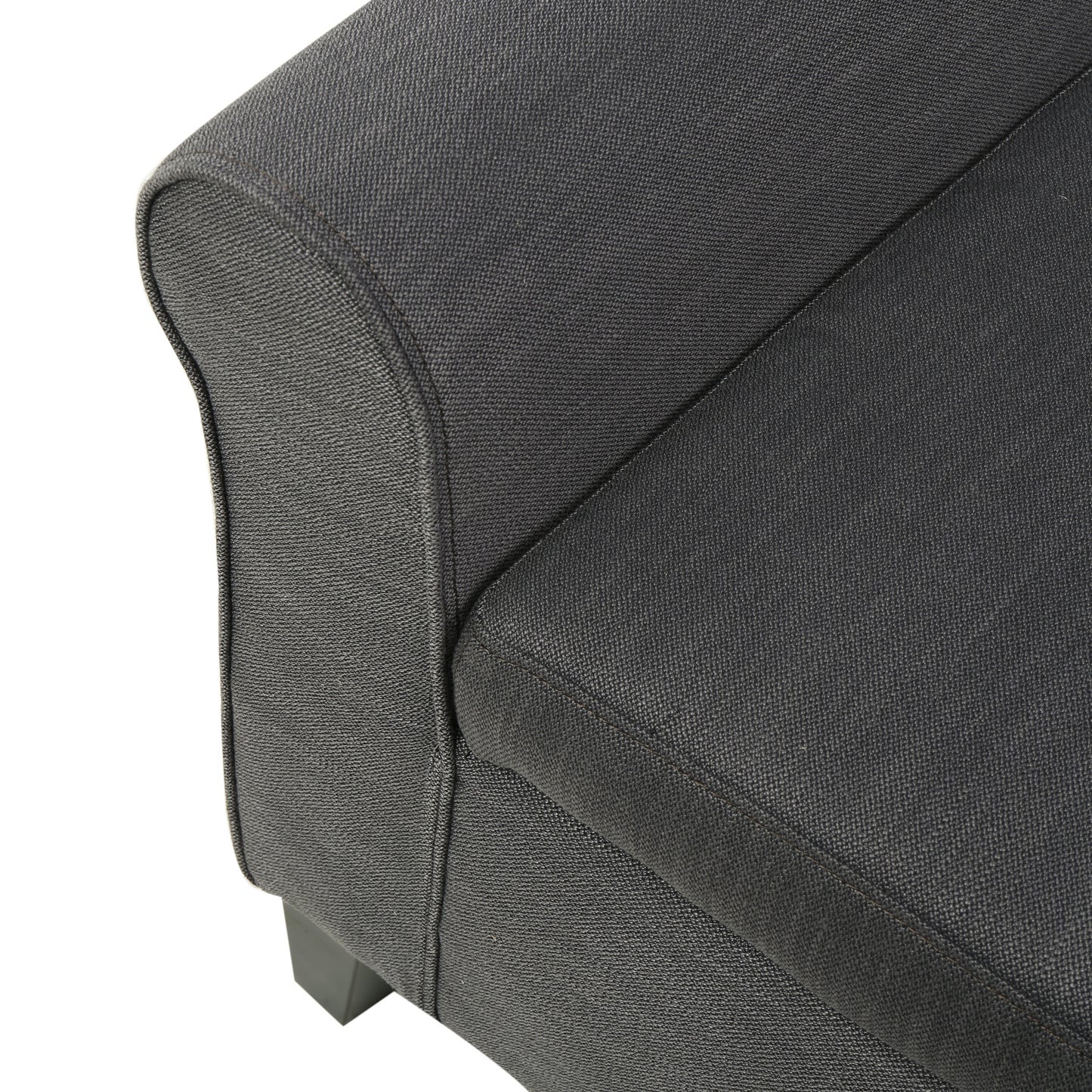 Closeup of textured dark gray fabric sofa armrest with stitching detail