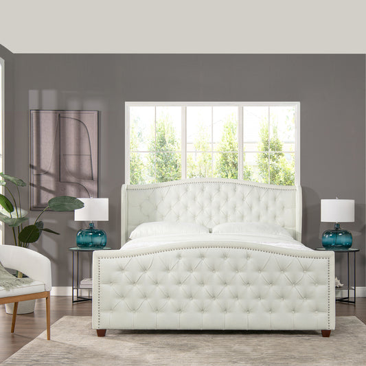 White tufted velvet wingback bed with diamond button tufting and silver nailhead trim