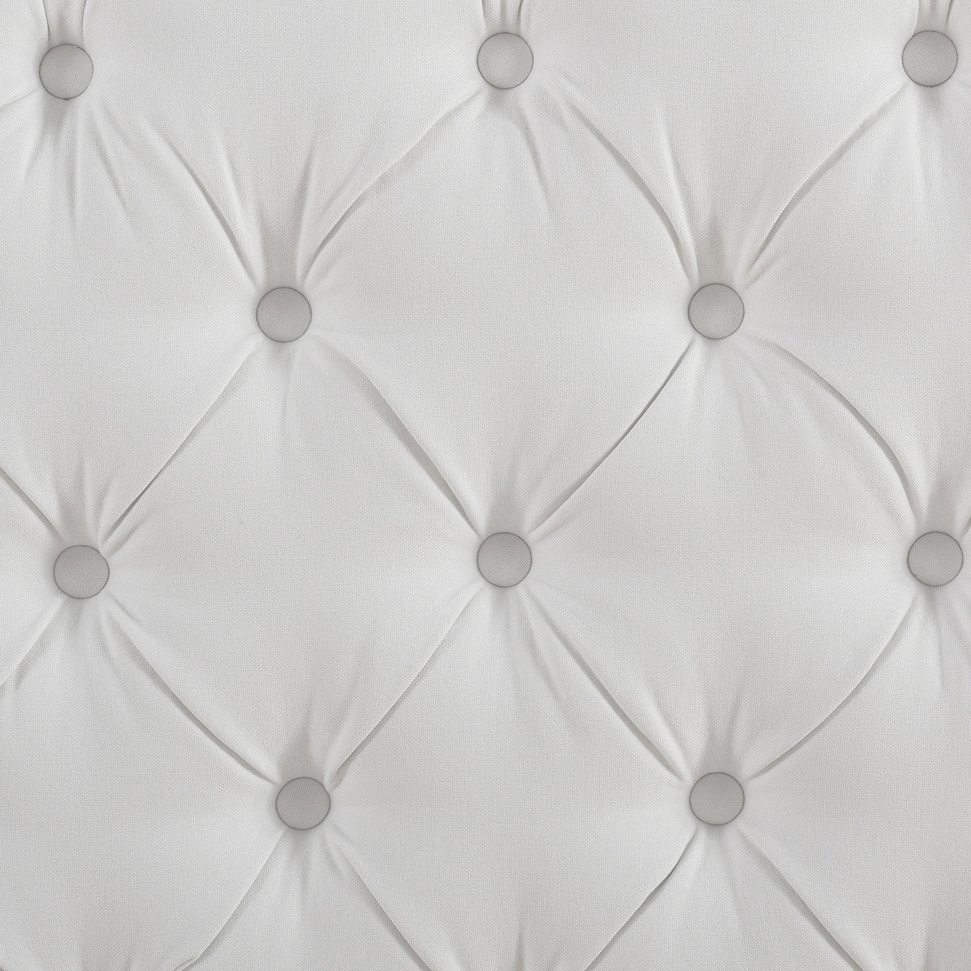 White tufted fabric headboard with silver buttons