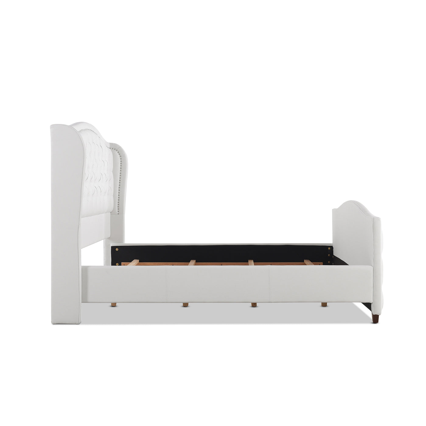 White tufted wingback upholstered bed frame with nailhead trim detail