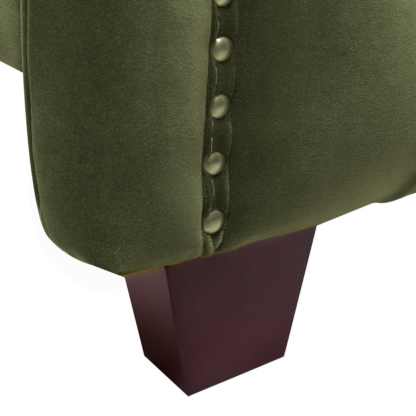 Olive green velvet armchair detail with brass studs and dark wood leg
