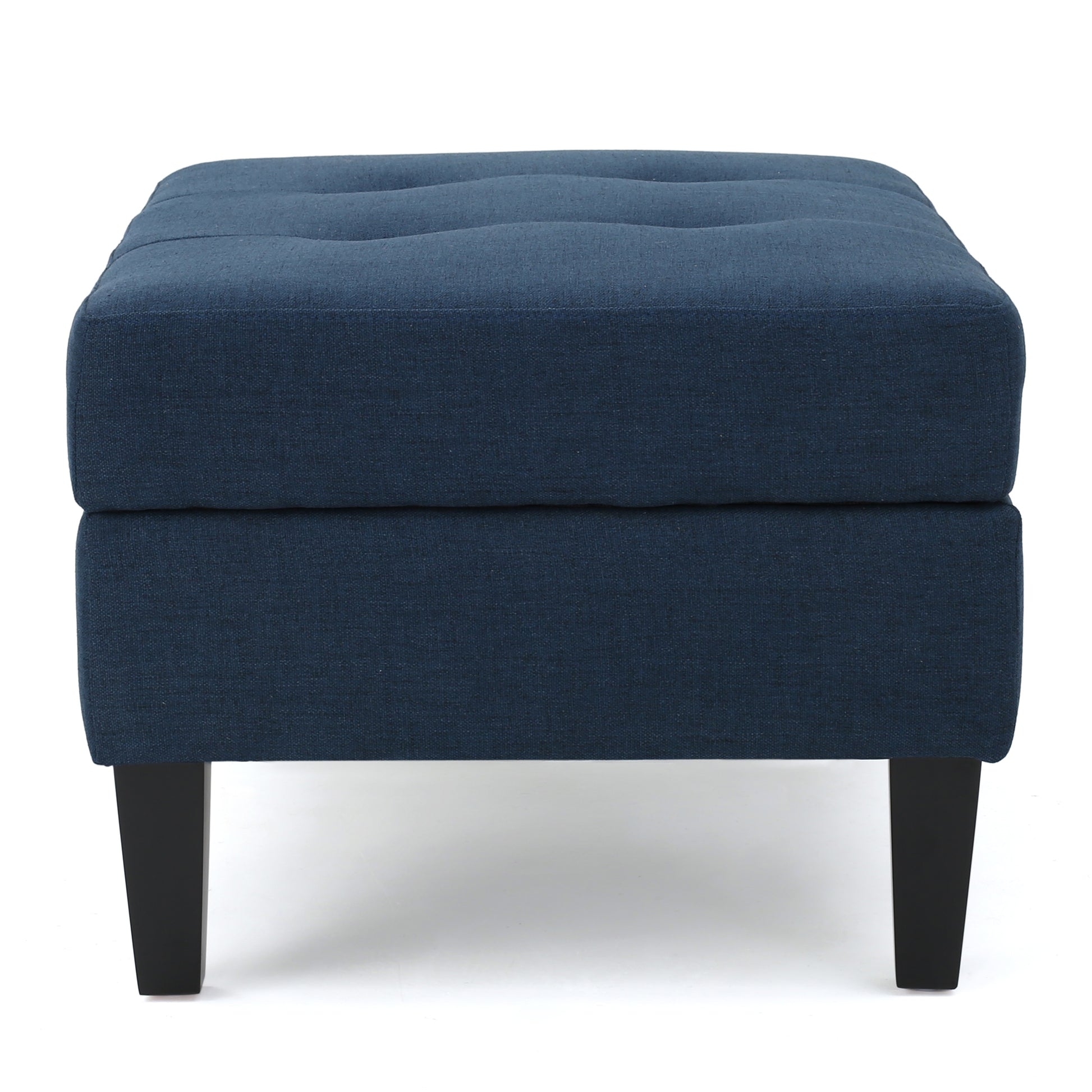 Dark blue upholstered ottoman with tufted top and black legs