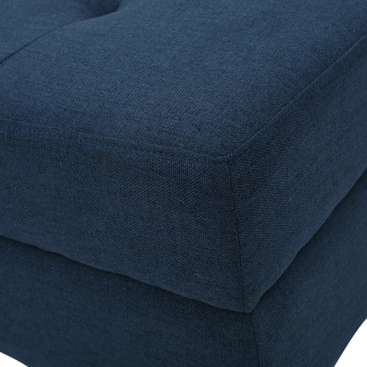 Closeup of textured navy blue fabric ottoman corner