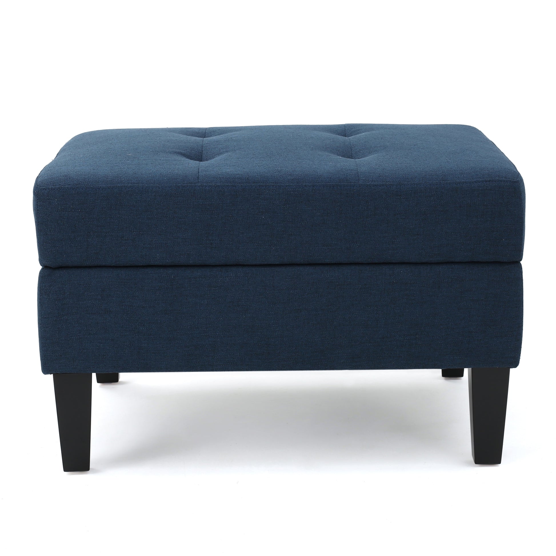 Tufted navy blue fabric ottoman with dark wooden legs and silver buttons
