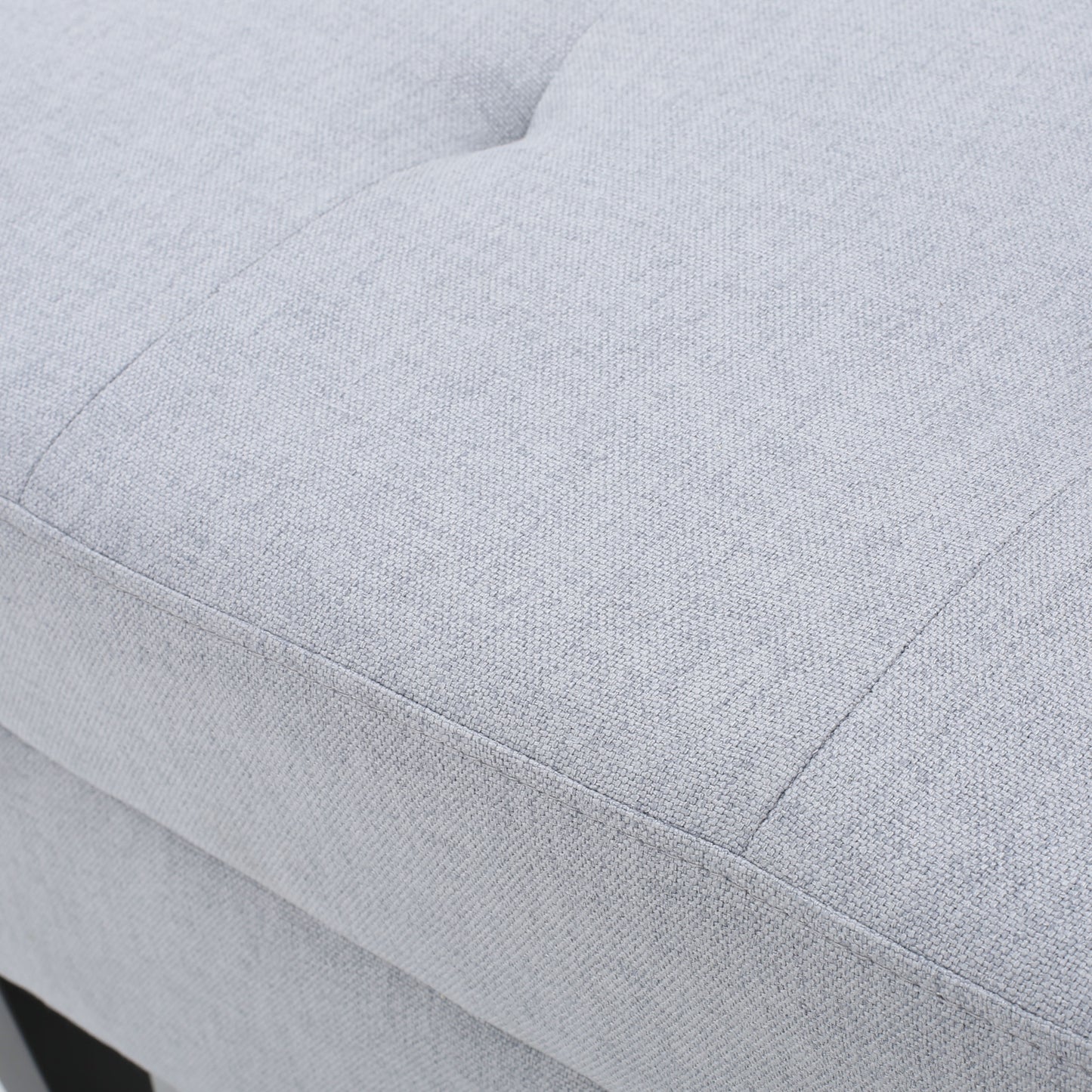 Light gray upholstered ottoman detail