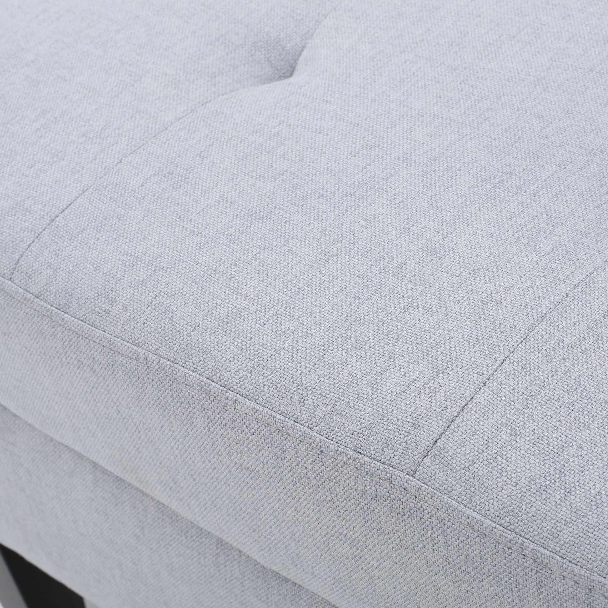 Light gray upholstered ottoman detail