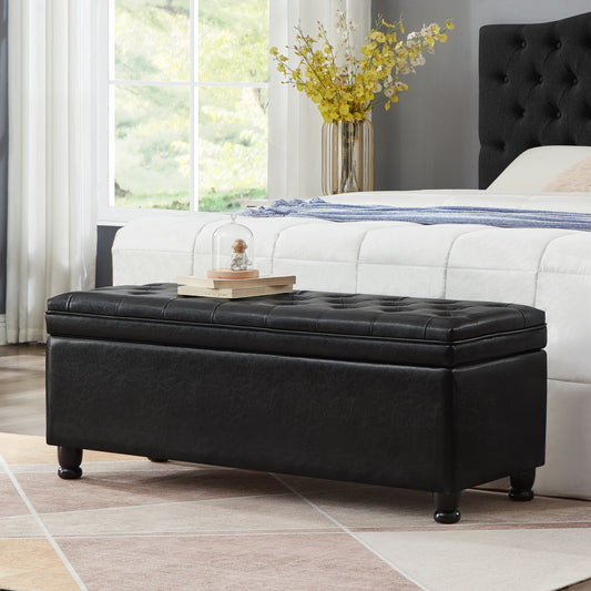 Black faux leather tufted storage ottoman with dark wood legs