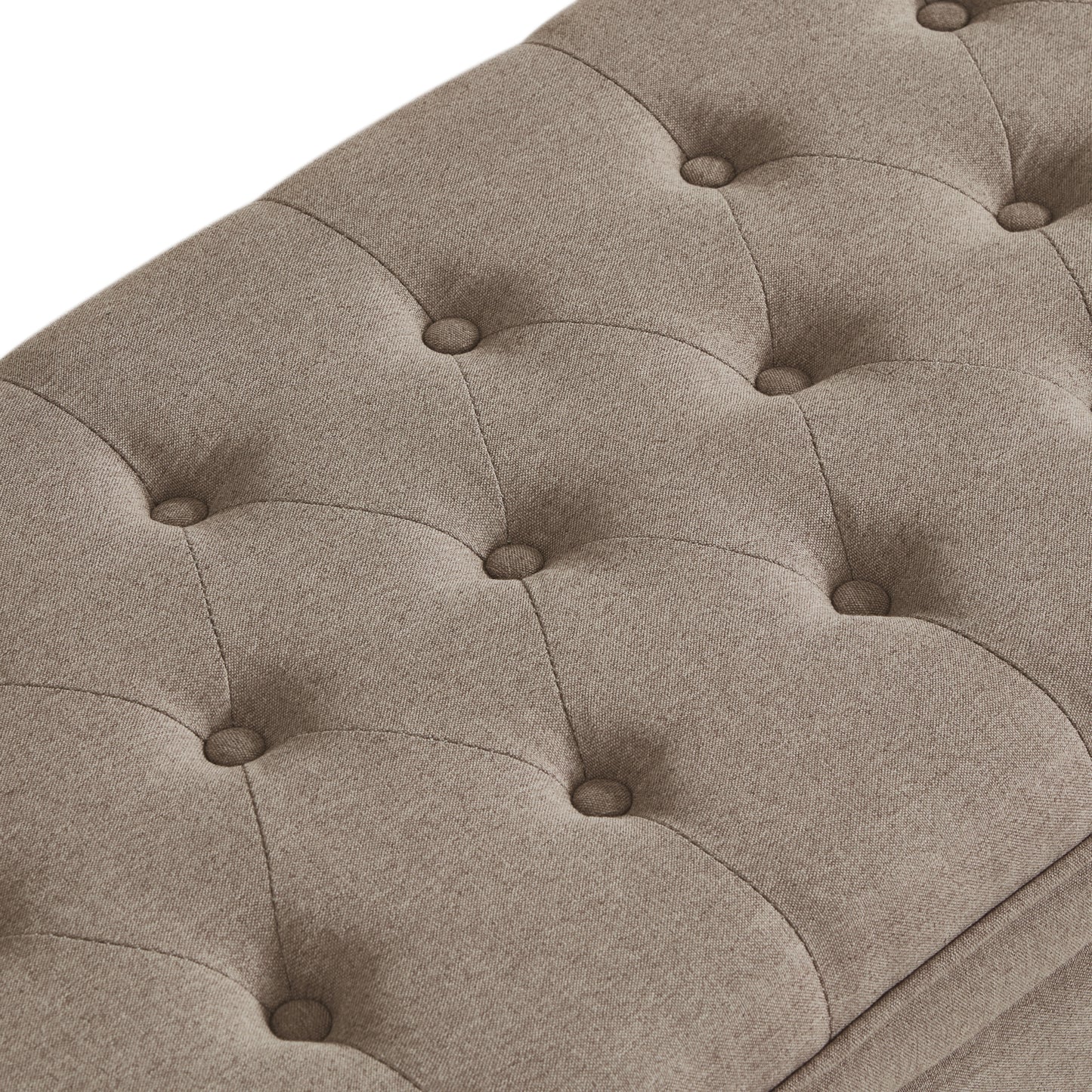 Closeup of tufted beige fabric bench with button details