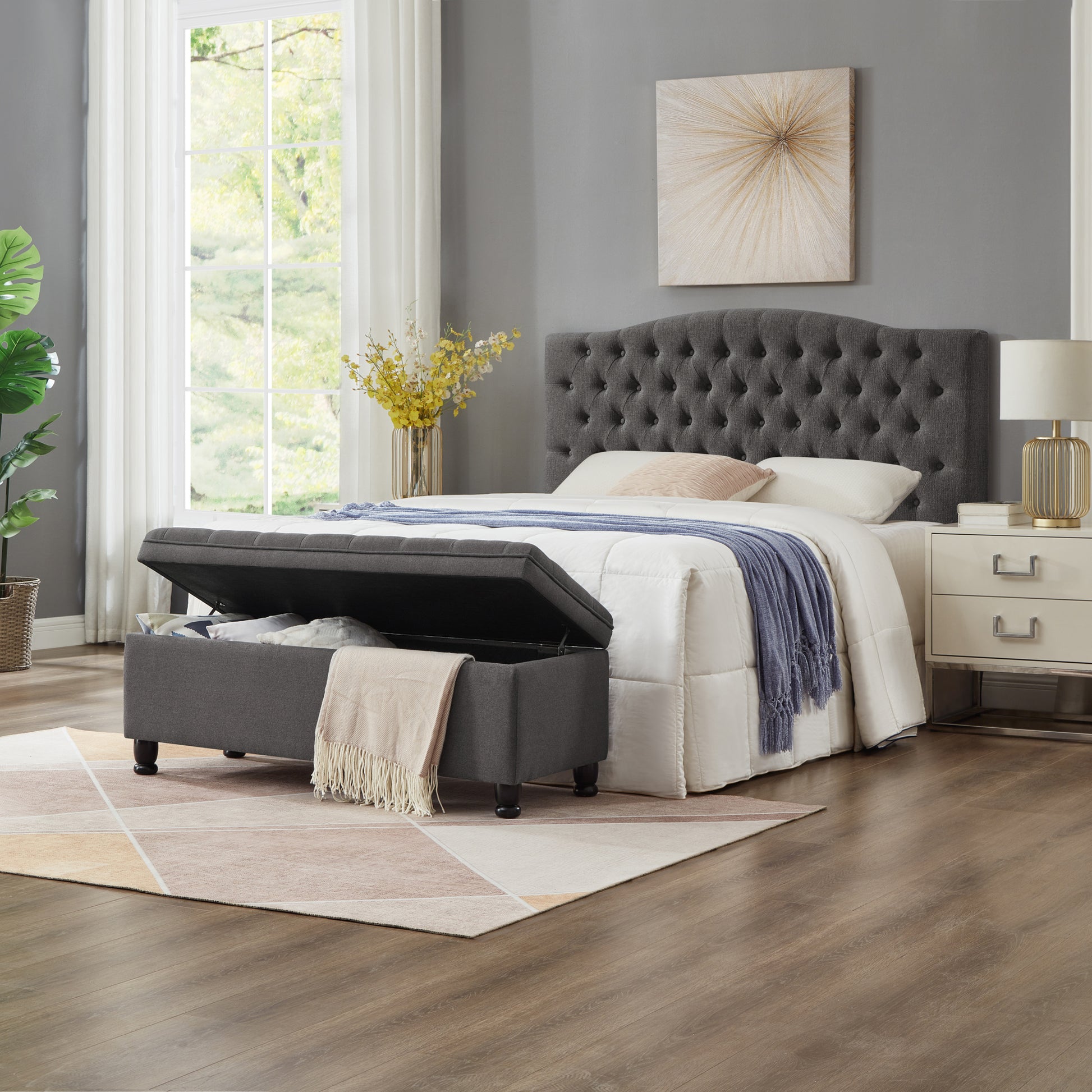 Dark gray tufted headboard queen bed with storage ottoman open