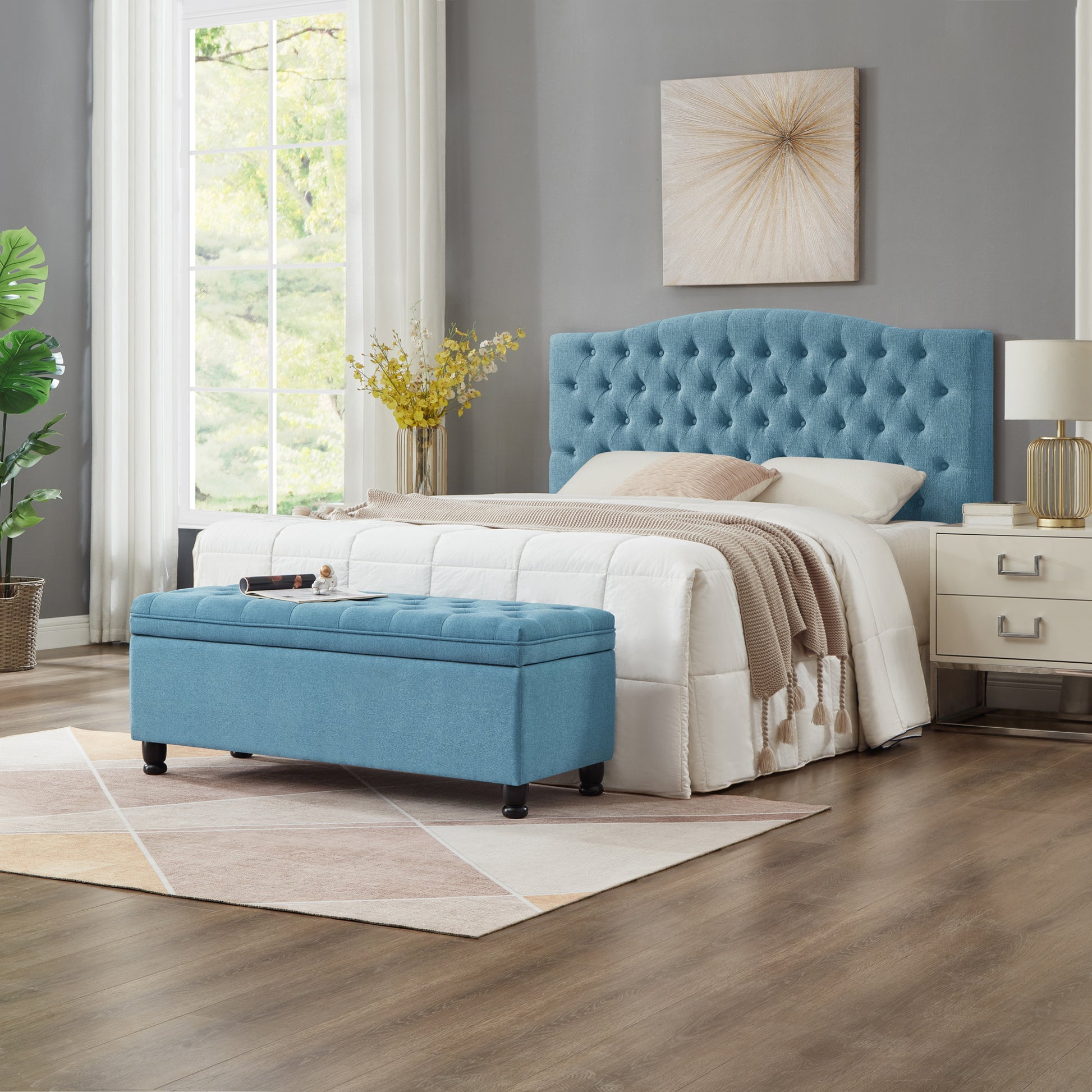 Tufted blue fabric storage ottoman with dark wooden feet