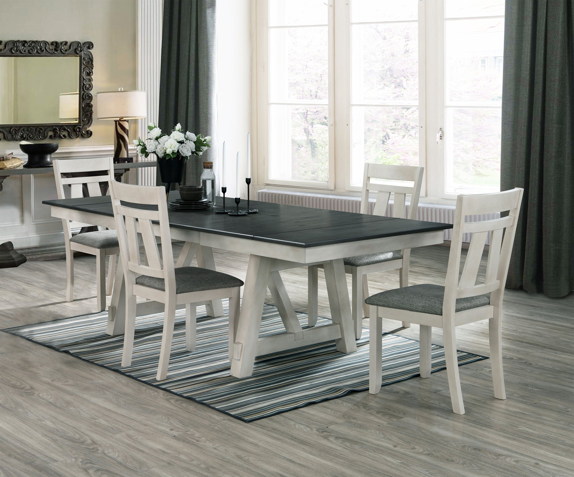 Farmhouse dining table with distressed white trestle base and charcoal top