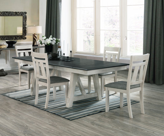 Farmhouse dining table with distressed white trestle base and charcoal top
