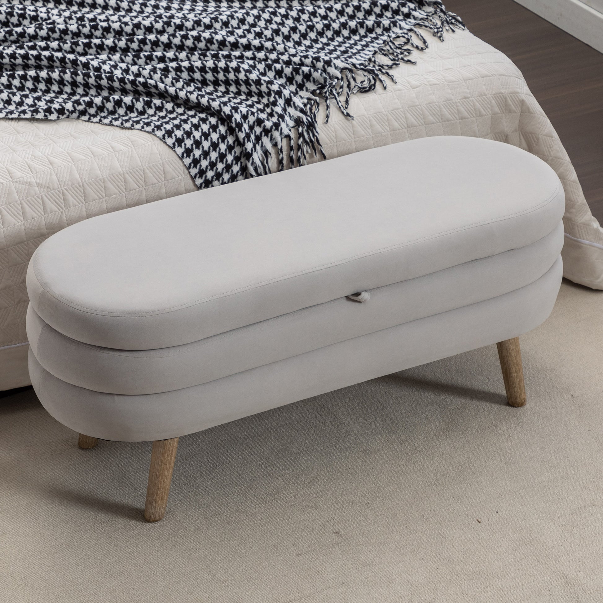 Light grey velvet storage bench with wooden legs
