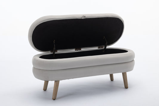 Light grey upholstered storage bench with open lid and wooden legs