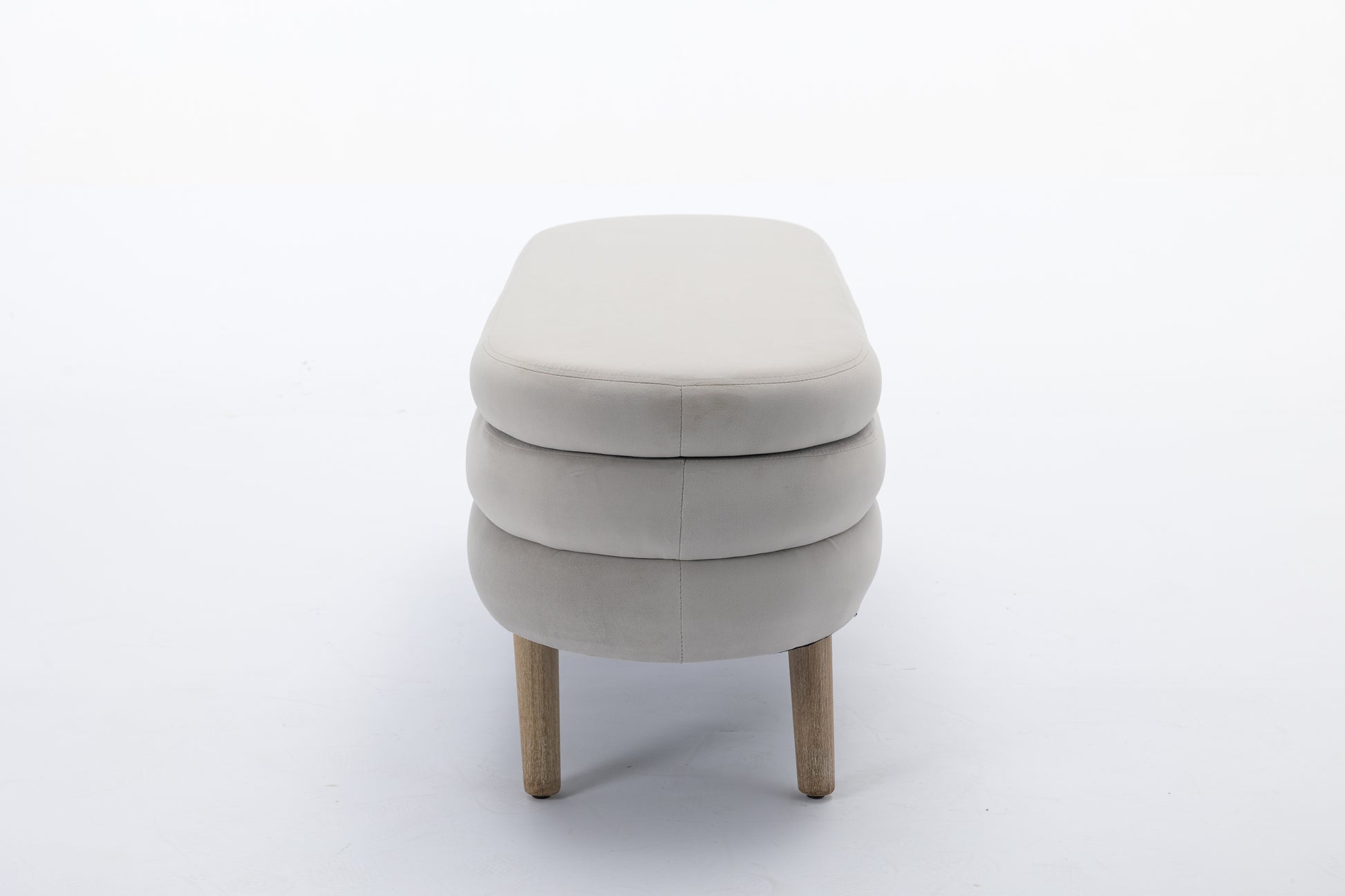 Cream upholstered bench with stacked design and wooden legs