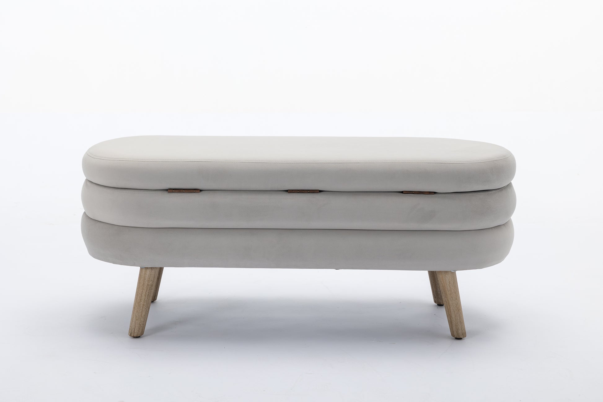 Light grey velvet storage ottoman with three stacked sections and wooden legs