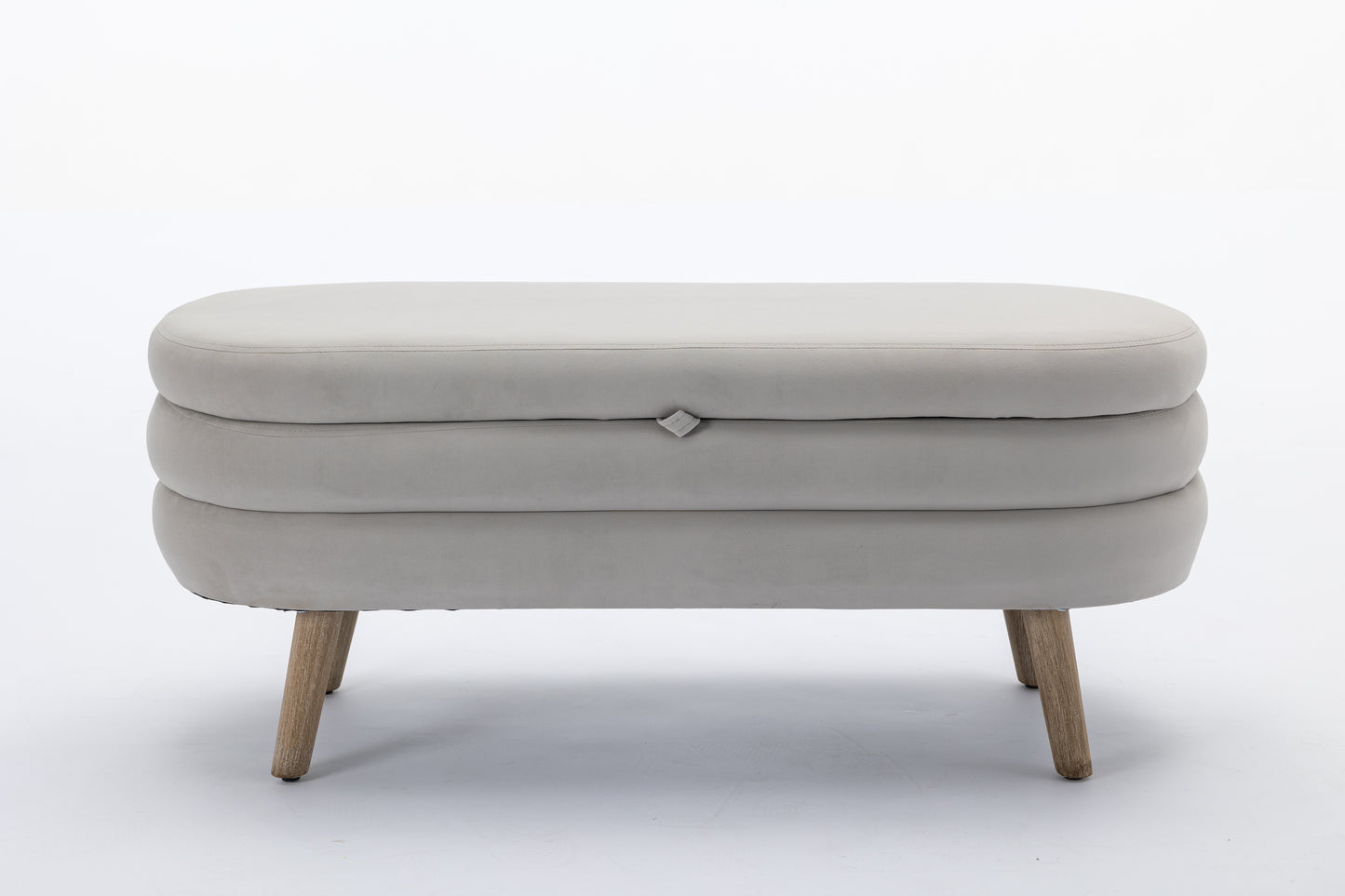 Modern grey upholstered ottoman with a rounded silhouette and wood legs