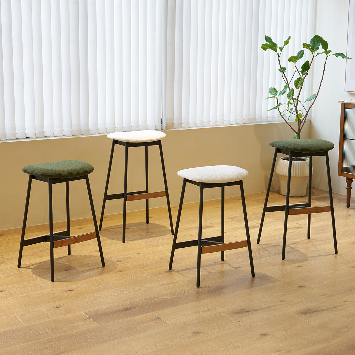 Modern black metal bar stool with green boucle seat