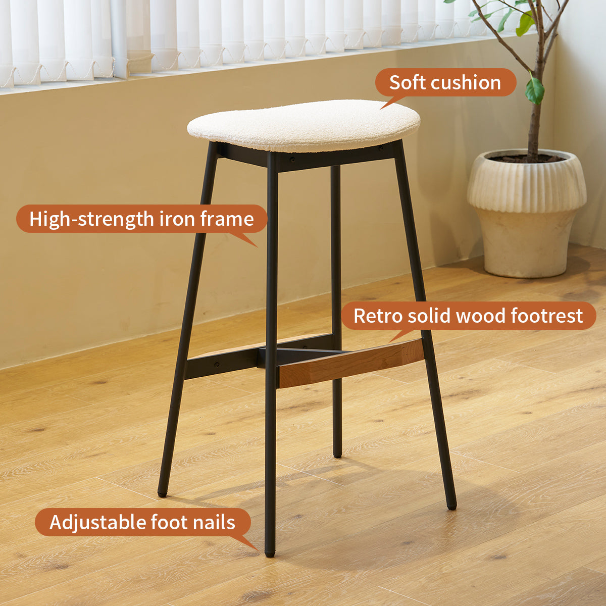 Cream boucle fabric bar stool with black iron frame and wood footrest