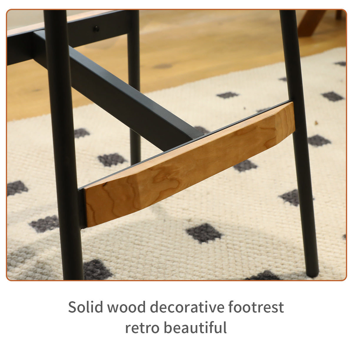 Wooden footrest detail on modern black metal stool
