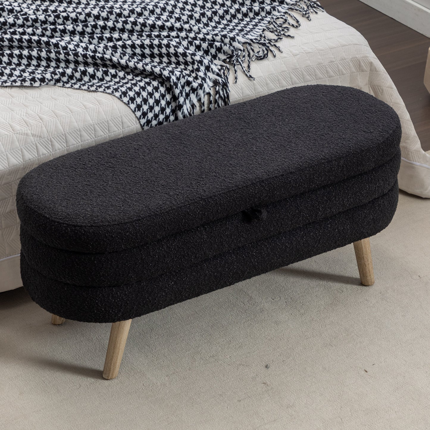 Black boucle ottoman with wooden legs