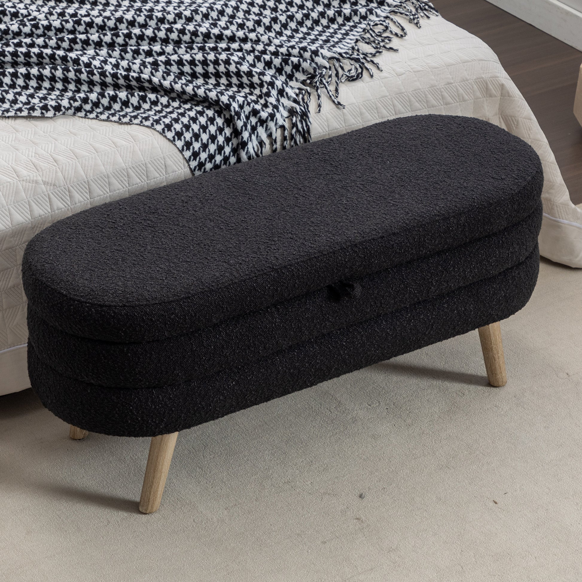 Black boucle ottoman with wooden legs