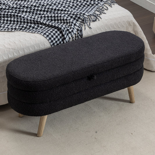 Black boucle ottoman with wooden legs