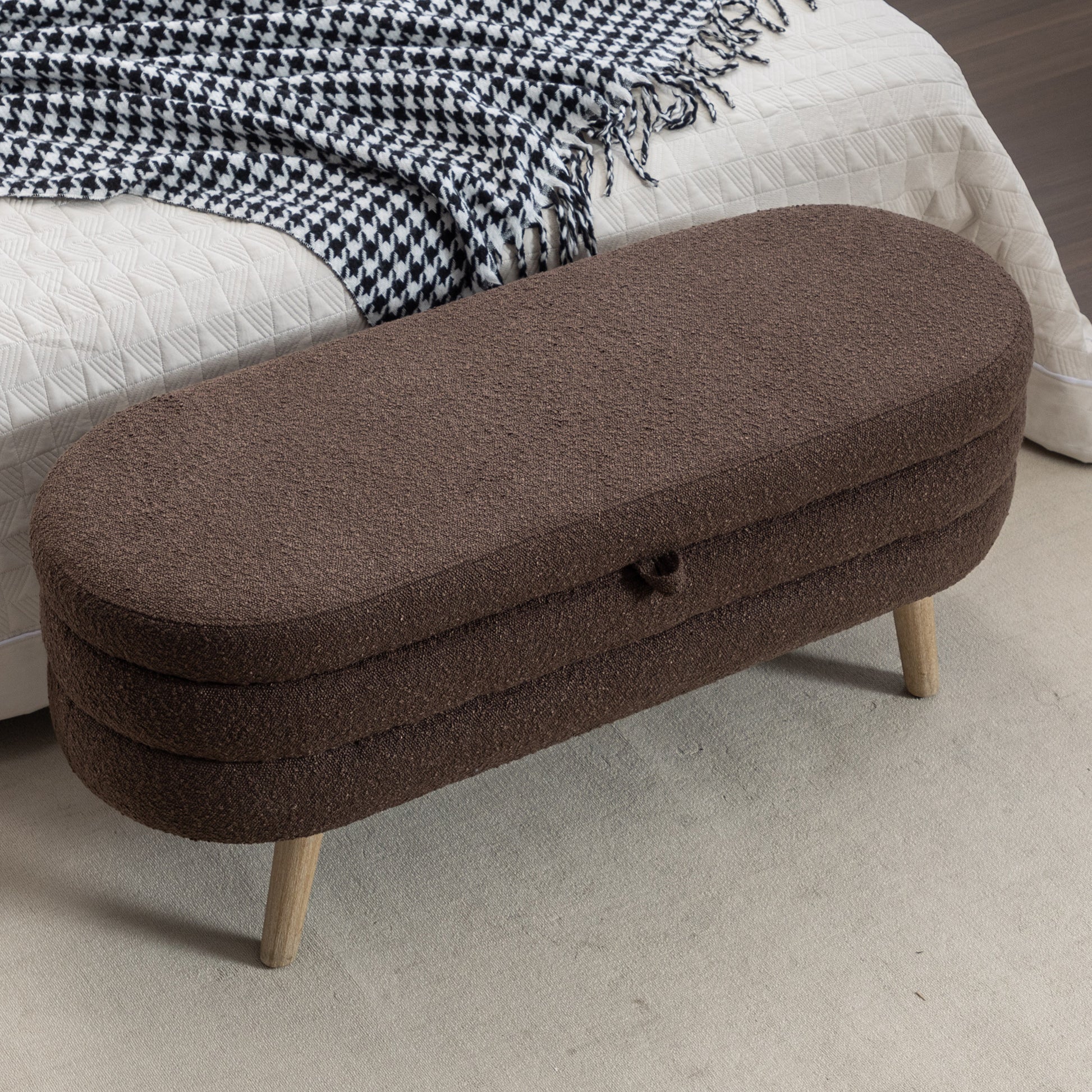 Brown oval storage ottoman with wooden legs