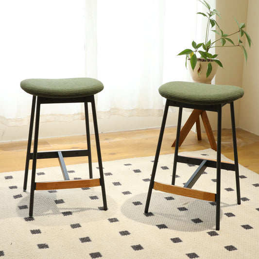 Green upholstered bar stools with black metal legs and wooden footrests