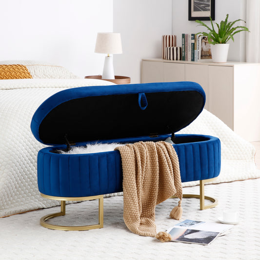 Royal blue velvet storage ottoman with gold base and open lid