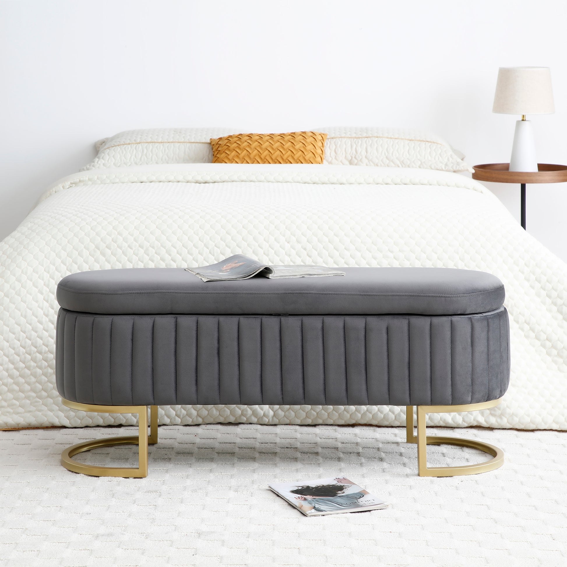 Grey velvet storage ottoman with fluted details and gold base