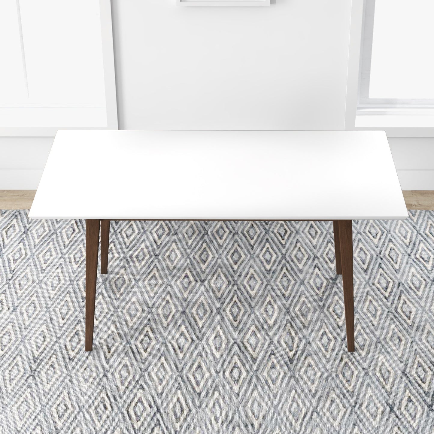 White rectangular dining table with dark wood legs on a geometric diamond rug