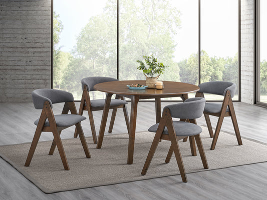 Round wood dining table with grey upholstered chairs