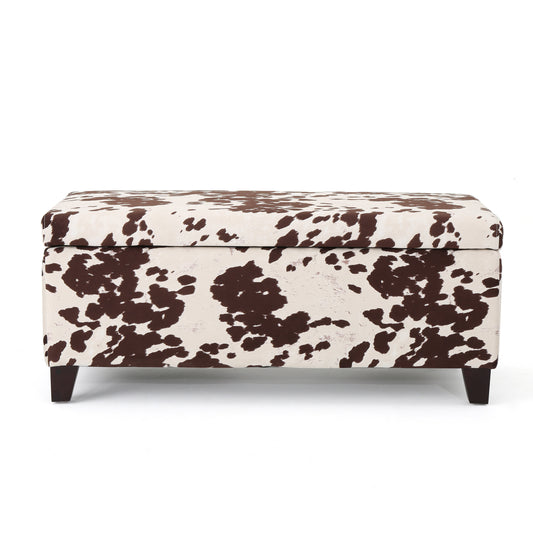Brown and white cowhide print storage ottoman with dark wood legs