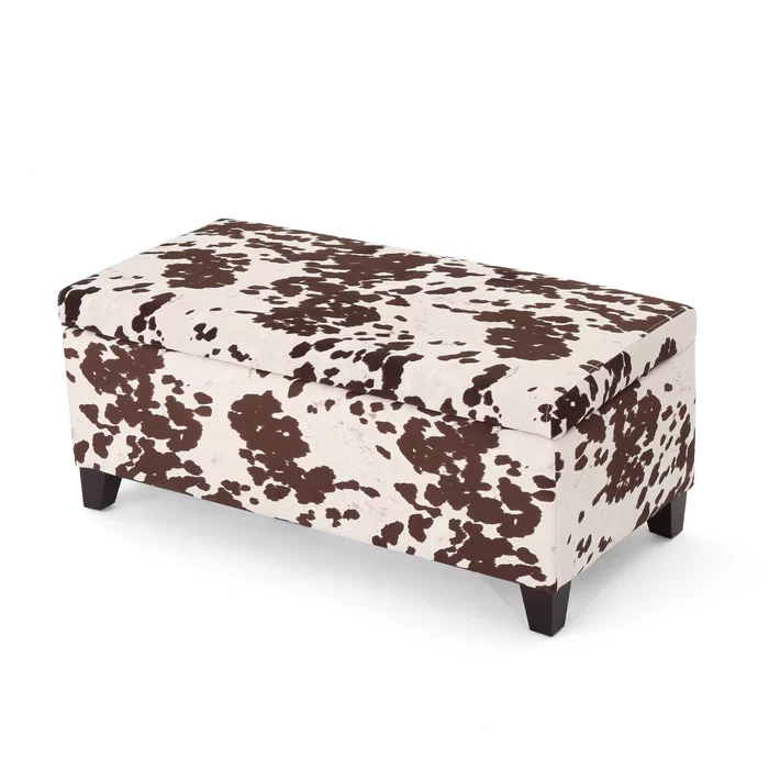 Brown and white cow print storage ottoman with dark wooden legs