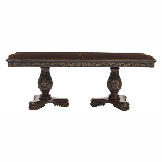 Ornate dark wood dining table with carved pedestal bases and gold accents