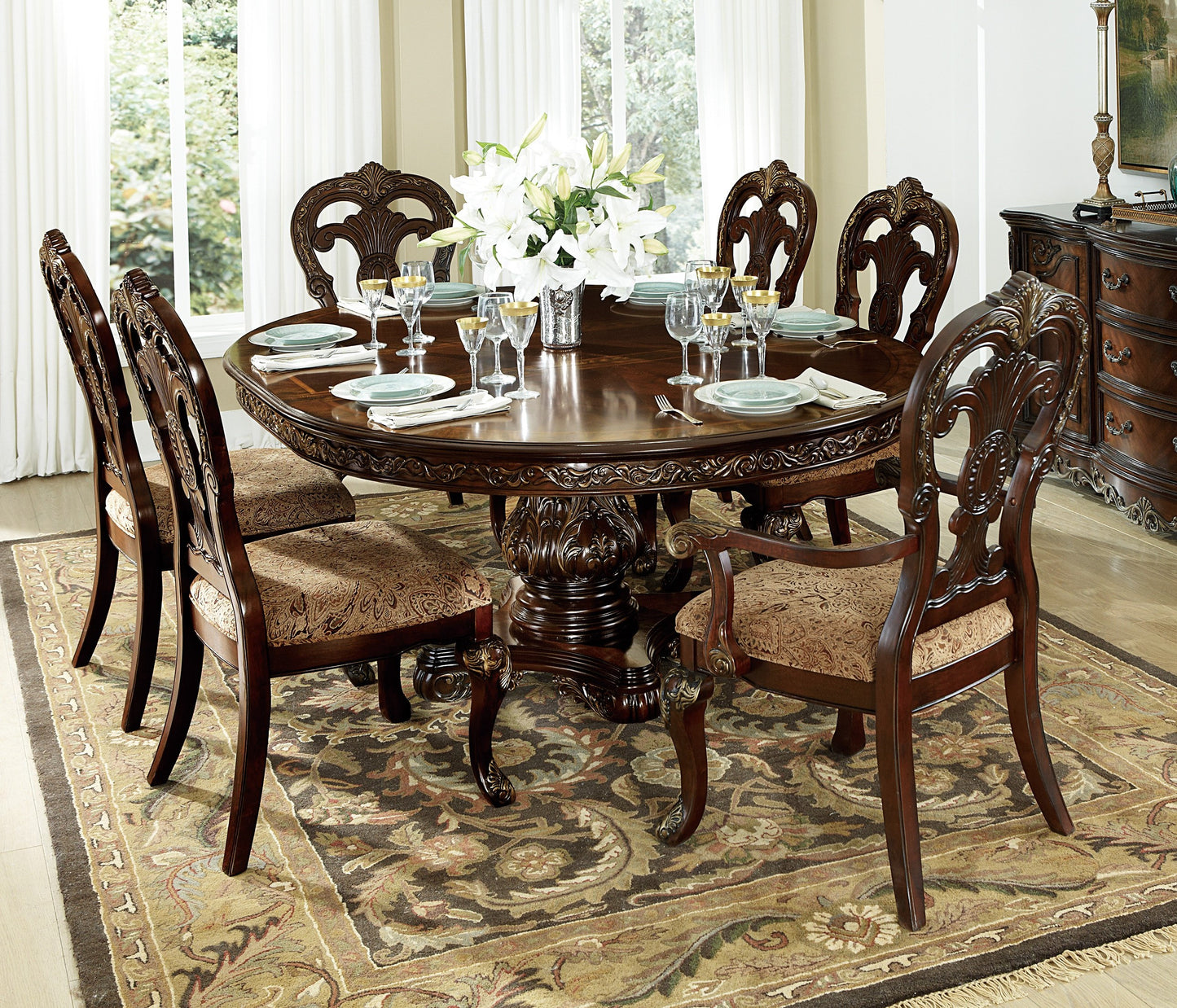 Ornate dark wood dining table with upholstered chairs