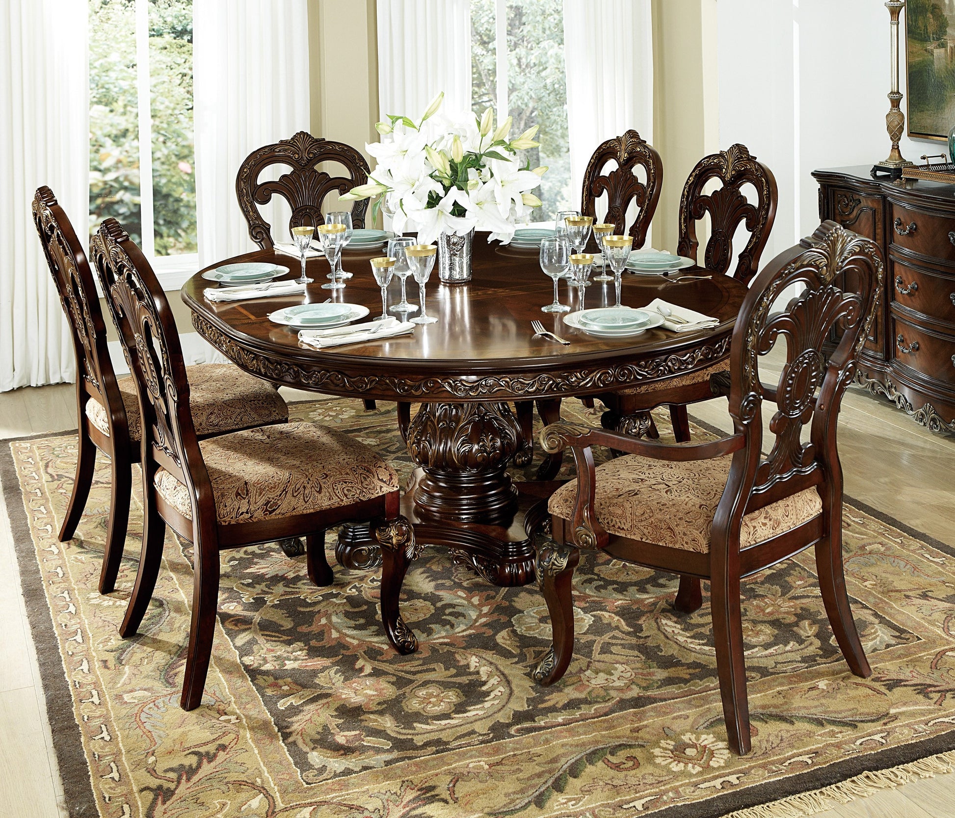 Ornate dark wood dining table with upholstered chairs