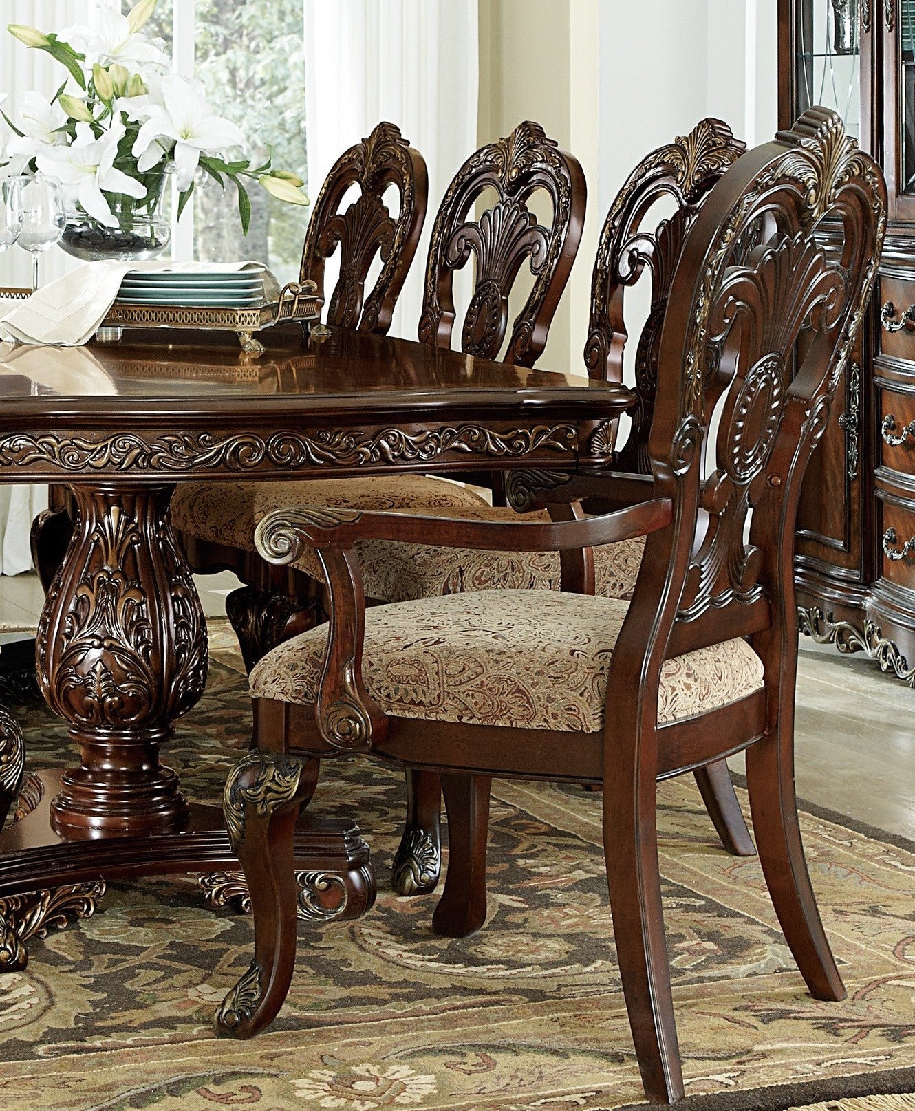 Ornate dark wood dining chair with upholstered seat