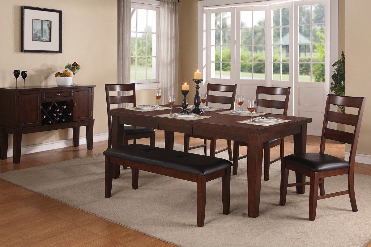 Dark wood dining table with bench seating and four chairs