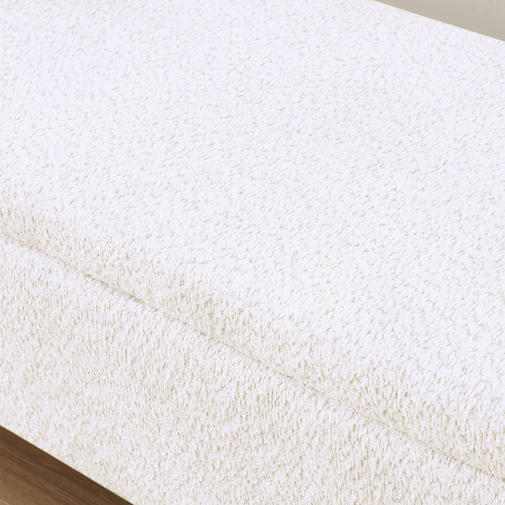 Cream boucl fabric texture on a modern ottoman