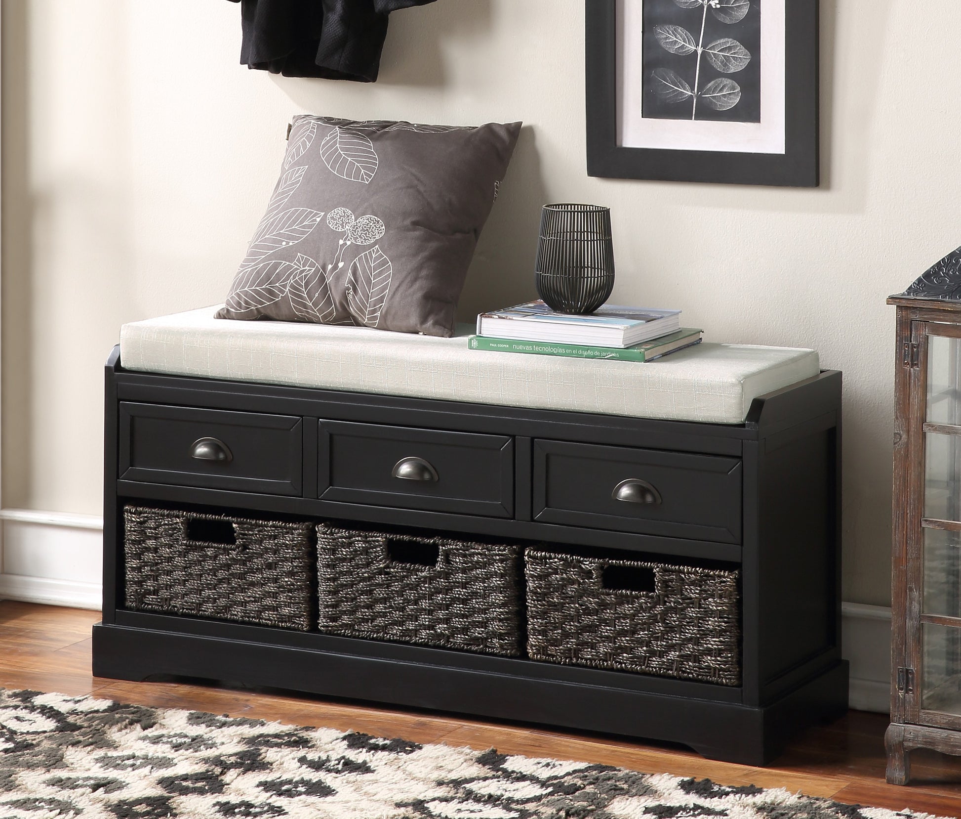 Black entryway bench with three drawers and three woven storage baskets