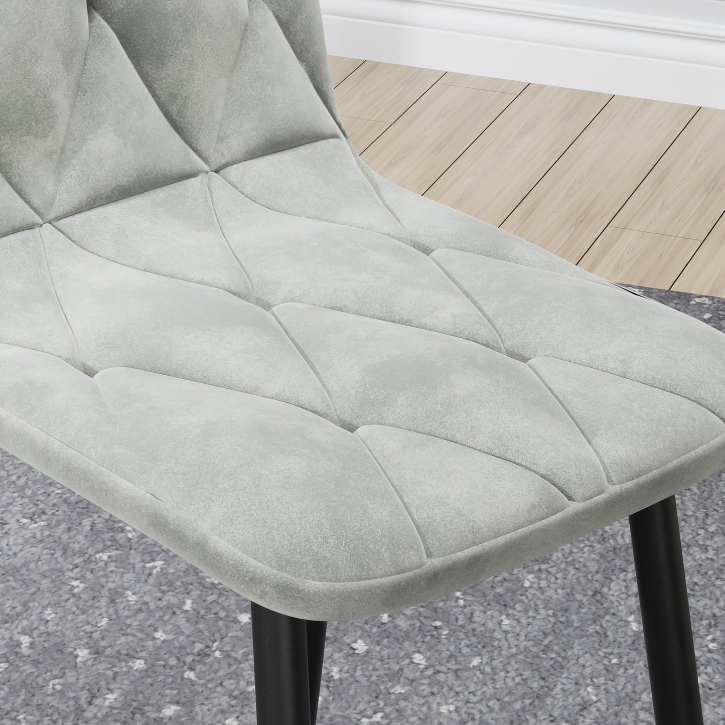 Grey velvet dining chair with diamond tufting and black metal legs