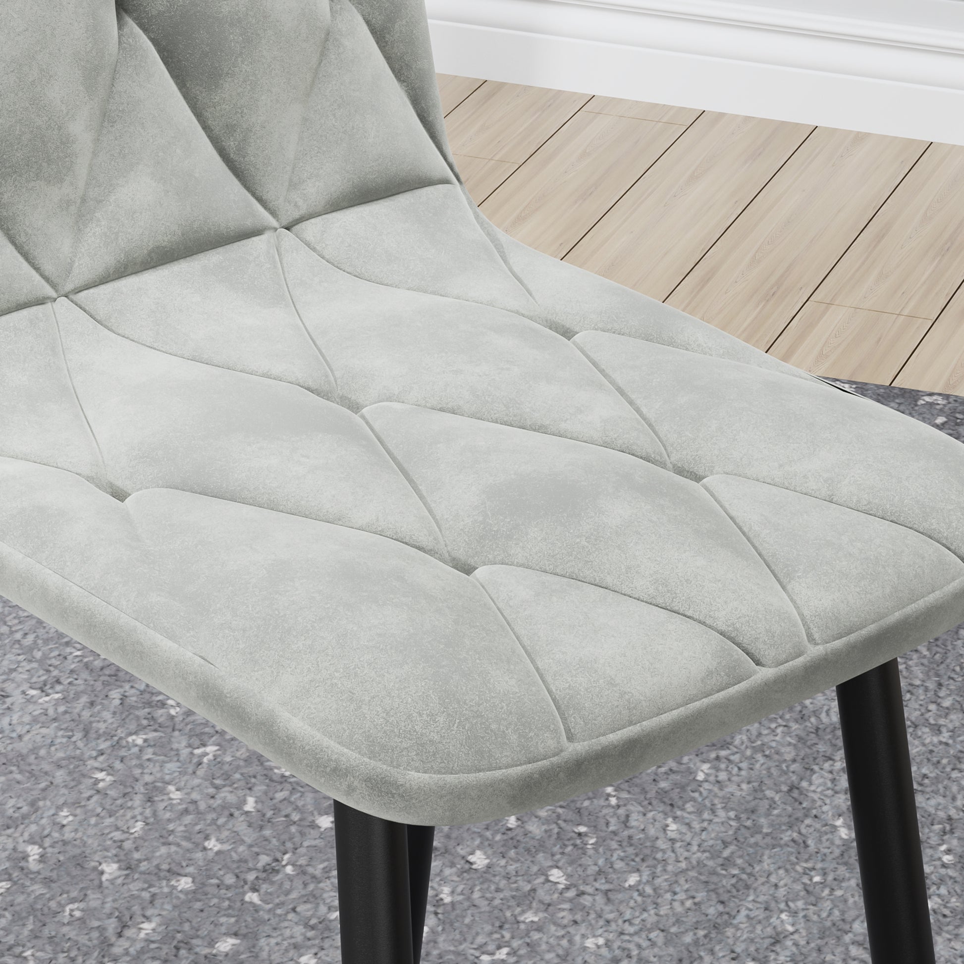 Grey velvet dining chair with diamond tufting and black metal legs