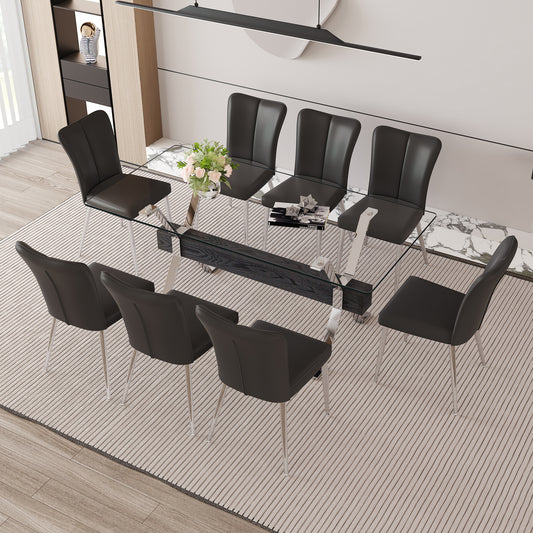 Modern glass dining table with eight black leather chairs and chrome legs