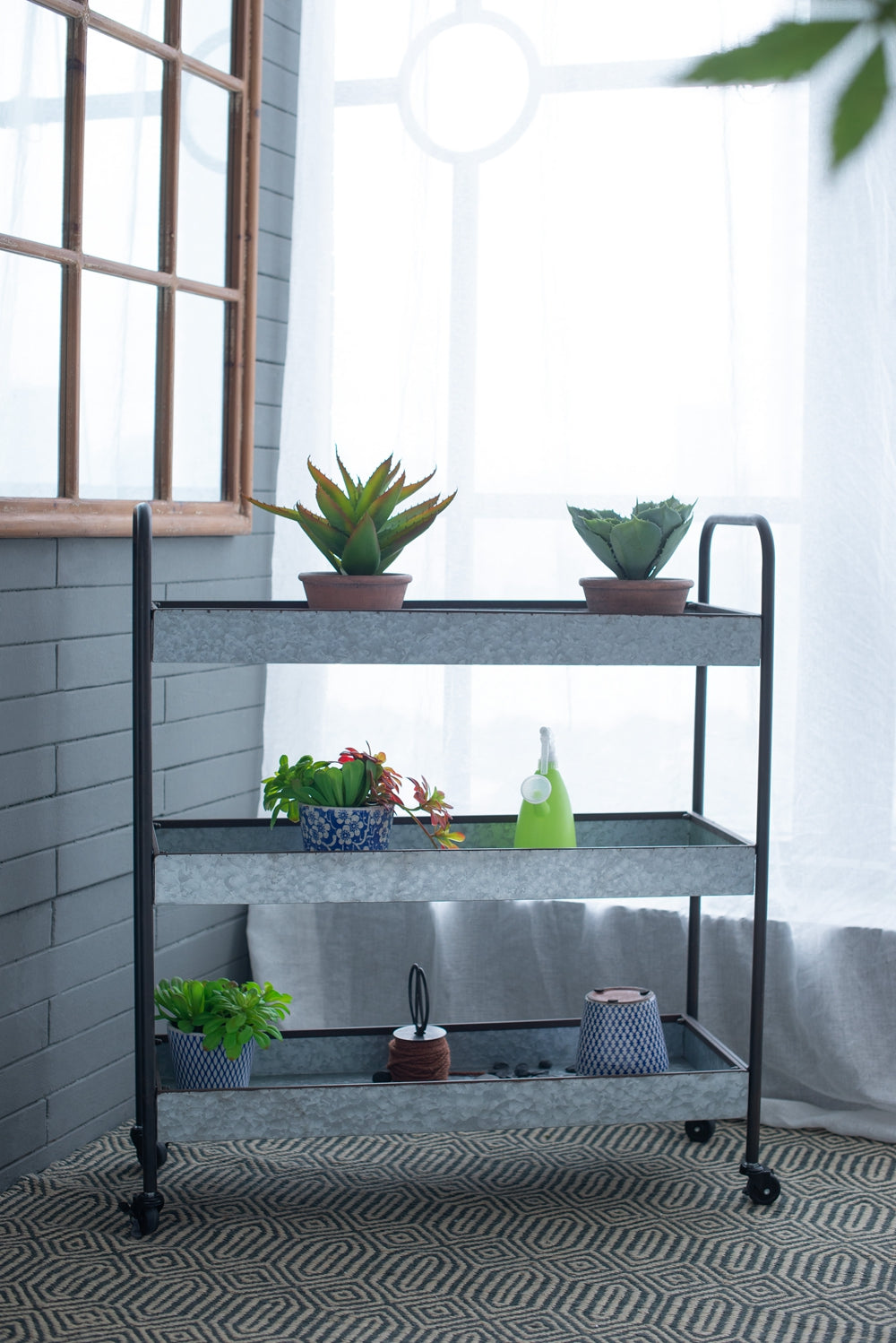 Galvanized metal tiered rolling cart with plants