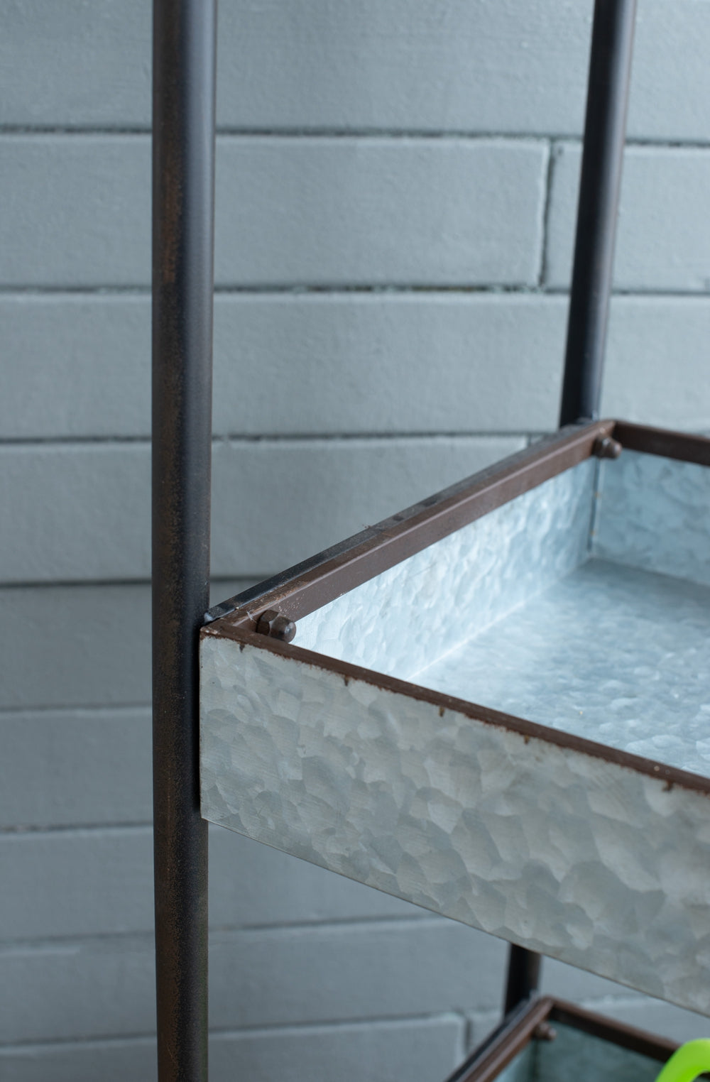 Rustic tiered galvanized metal plant stand with dark brown frame