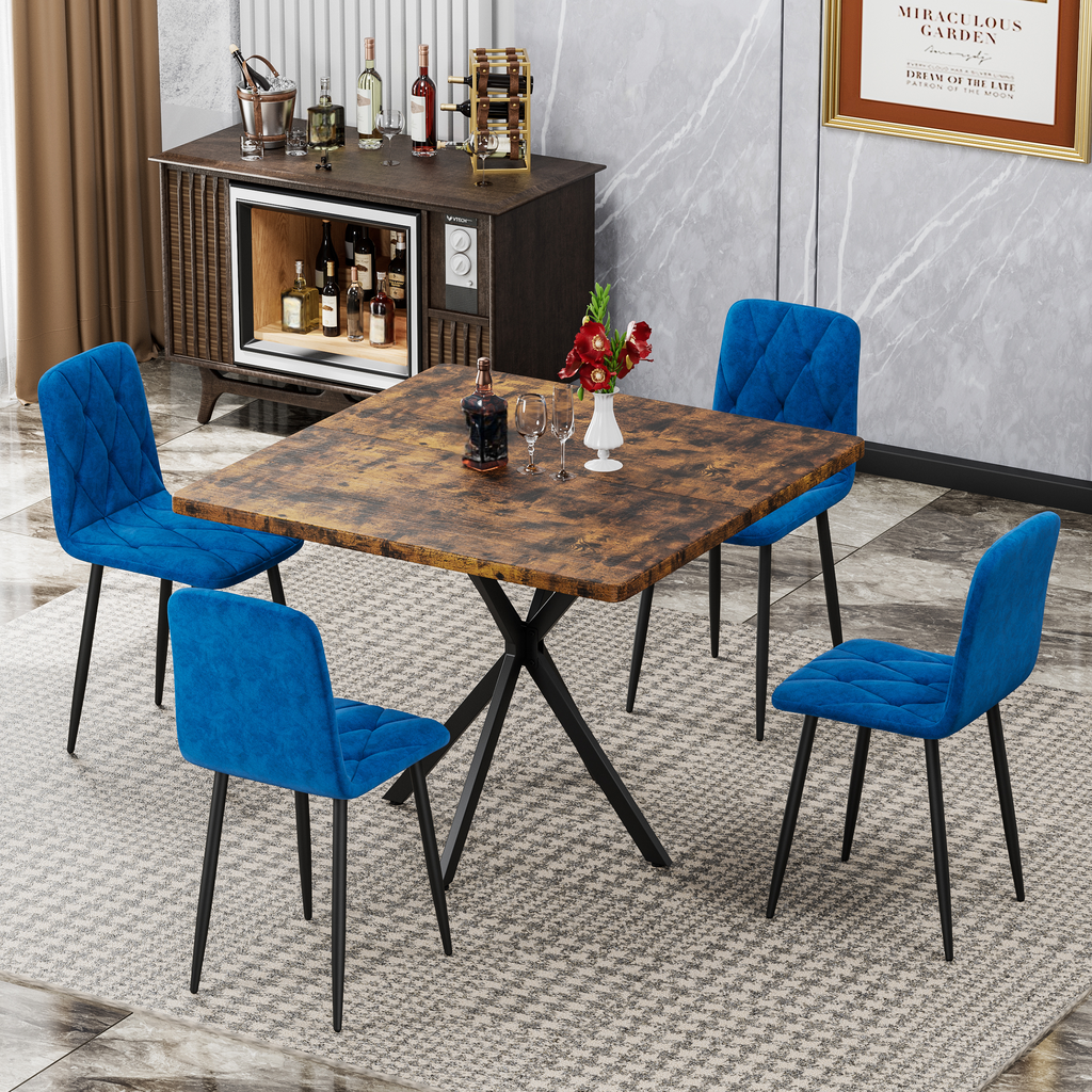 Rustic dining table with four blue velvet chairs and black metal legs